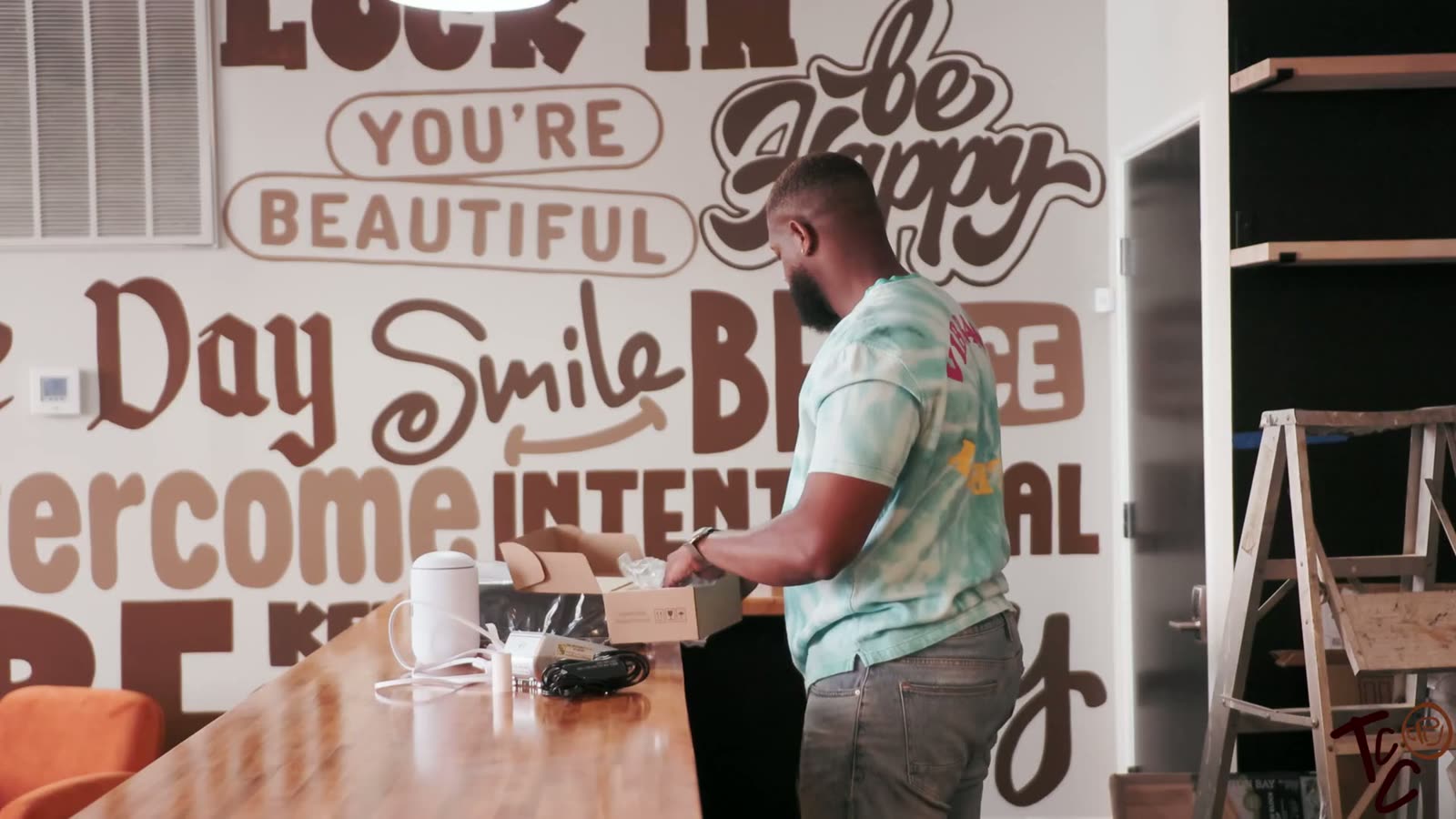 Hand-lettered mural with words like Overcome, Be Nice and Inspire